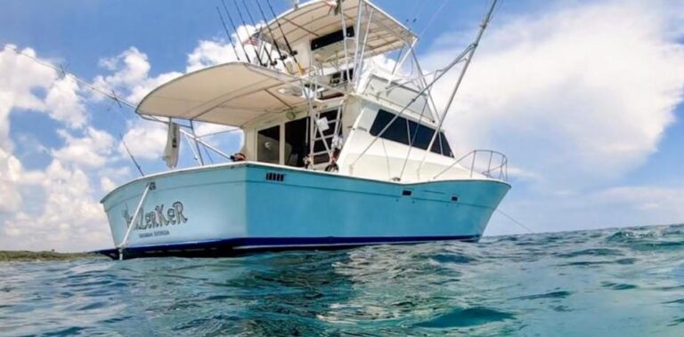 Front profile of 41 ft deep-sea fishing charter boat departing Puerto Aventuras marina into turquoise water for sportfishing at Riviera Maya