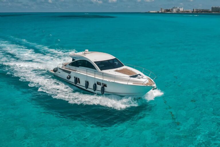 Aerial side view of 62 ft Fairline luxury yacht charter Tinto cruising across turquoise Caribbean waters near Cancun hotel zone