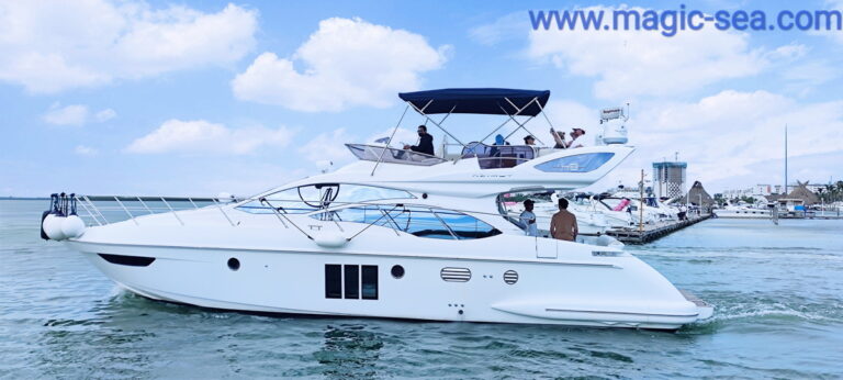 50 ft Azimut yacht rental in Cancun with a guest posing on the bow, RIU hotel and marina in the background